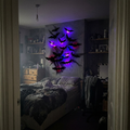 Glow Bats glowing purple in a dark bedroom doorway view