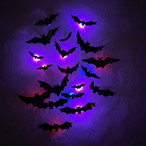 Close-up of glowing purple 3D bats on a wall